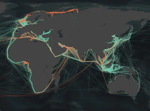 A dark map of the world shows glowing orange and teal lines tracing major sea routes and shipping lanes across the oceans, highlighting global maritime traffic patterns.